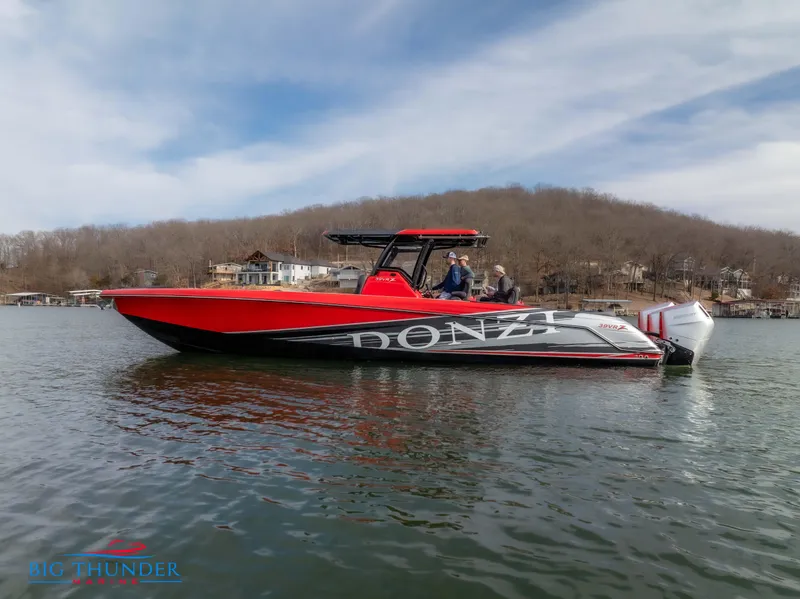 Slide: The Image of 2024 Donzi 39 VRZ boat on a lake with a scenic background. - 5