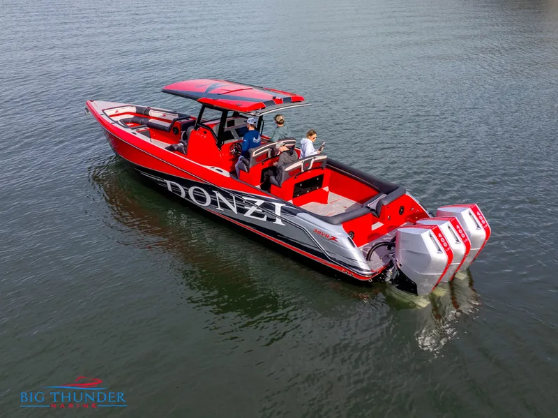 Slide: The Image of 2024 Donzi 39 VRZ boat on water, red and black design, triple outboard engines. - 6