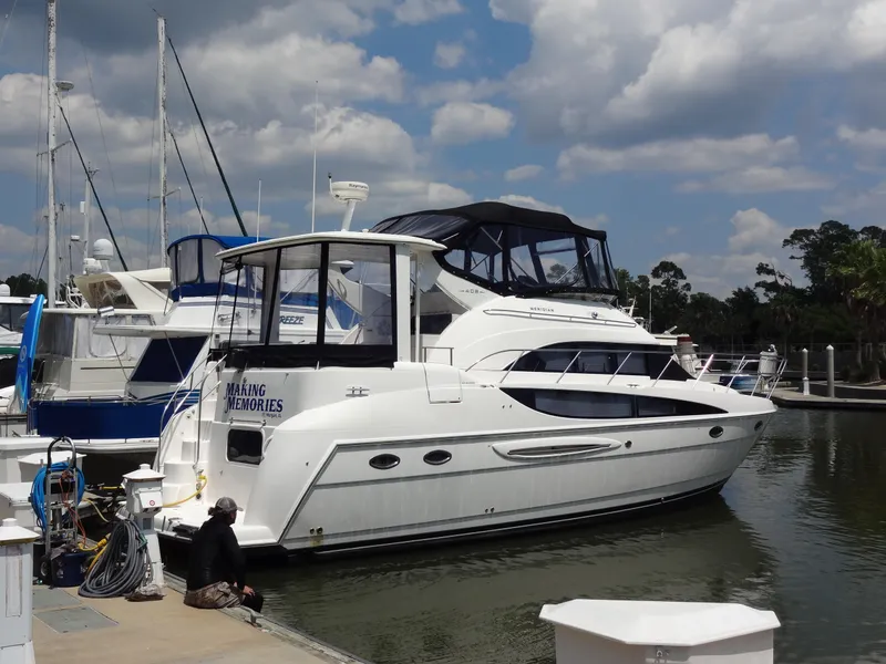 Slide: The Image of 2004 Meridian 408 Motoryacht docked at marina under cloudy sky. - 1