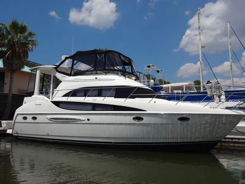 Slide: The Image of 2004 Meridian 408 Motoryacht docked at marina under blue sky. - 11