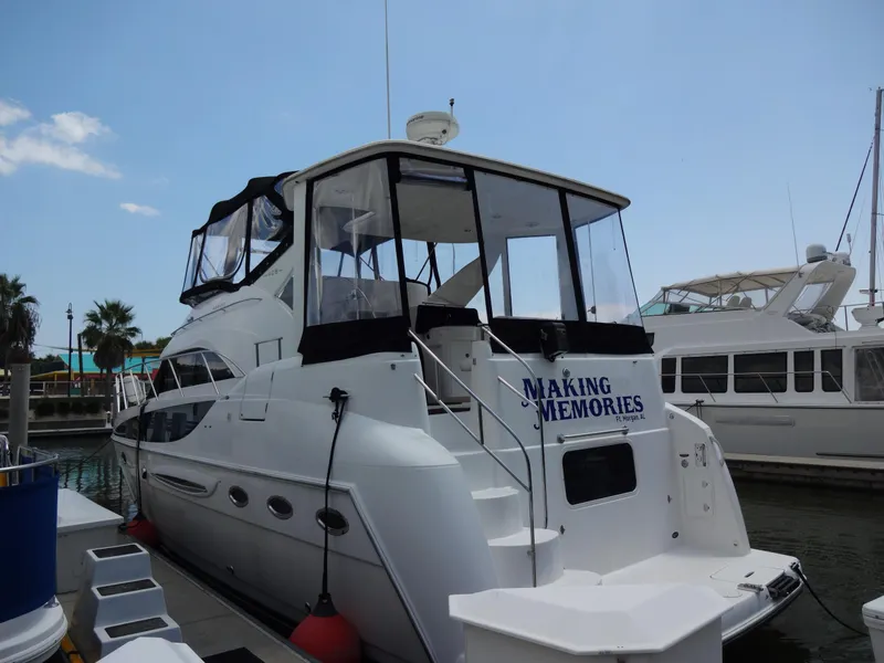 Slide: The Image of 2004 Meridian 408 Motoryacht docked, named Making Memories, with clear skies and nearby boats. - 3