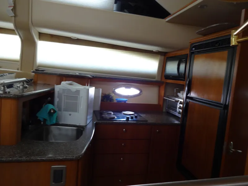 Slide: The Image of 2004 Meridian 408 Motoryacht kitchen with modern appliances and wood cabinetry. - 35