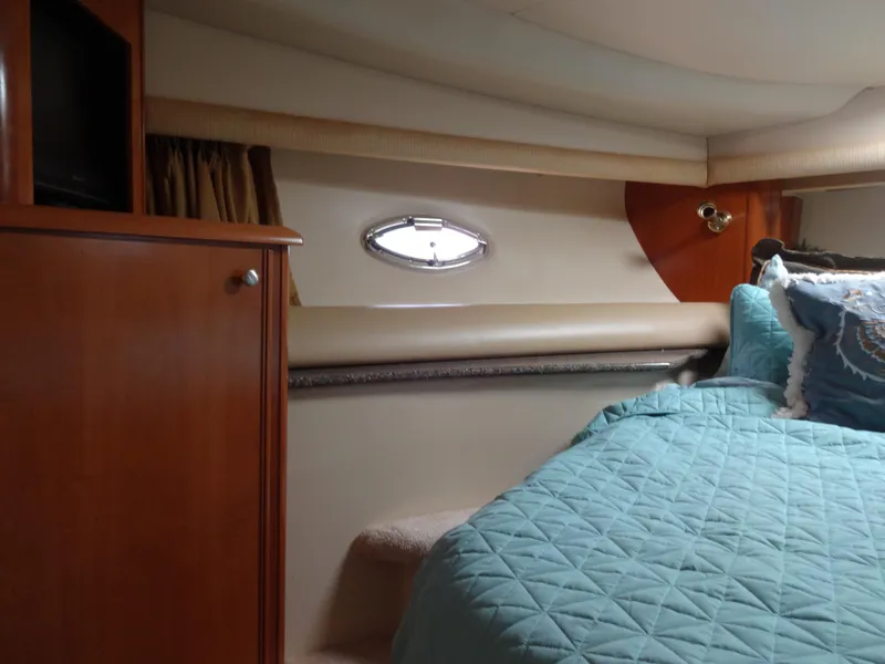 Slide: The Image of Interior cabin of 2004 Meridian 408 Motoryacht with blue bedding and wooden cabinetry. - 47