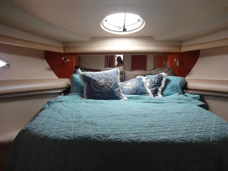 Slide: The Image of Luxurious bedroom interior of 2004 Meridian 408 Motoryacht with teal bedding and decorative pillows. - 49
