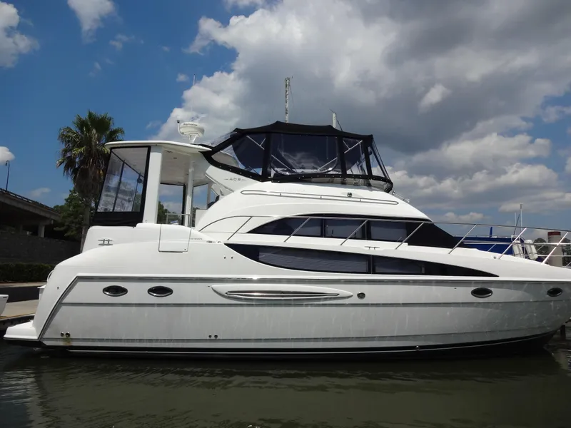Slide: The Image of 2004 Meridian 408 Motoryacht docked under a partly cloudy sky. - 8