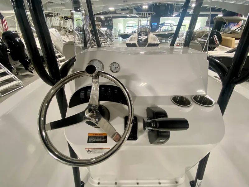 Slide: The Image of 2024 Savannah SS21 boat console with steering wheel and controls in showroom. - 13