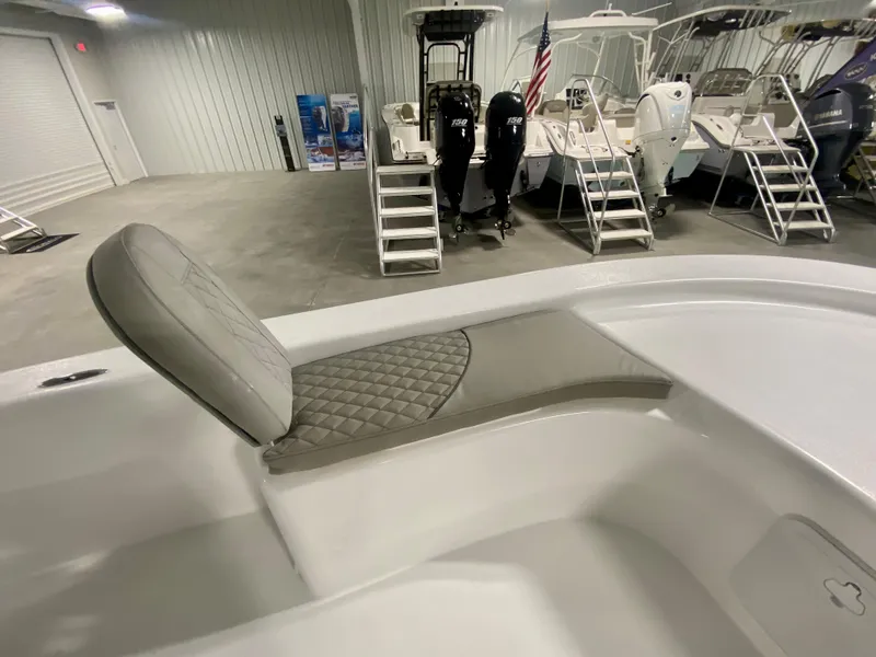 Slide: The Image of 2024 Savannah SS21 boat interior with cushioned seating in a showroom. - 19
