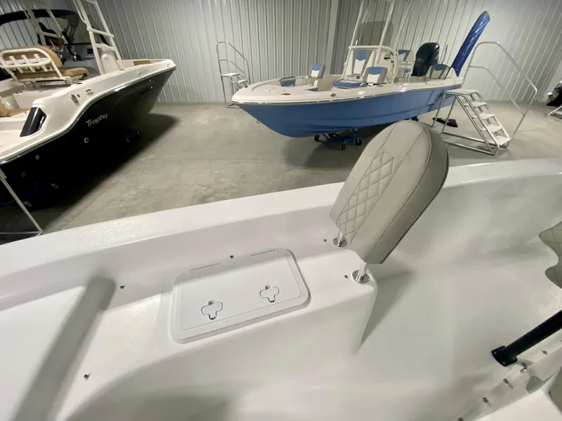Slide: The Image of 2024 Savannah SS21 boat interior with seating and storage, displayed in a showroom. - 22