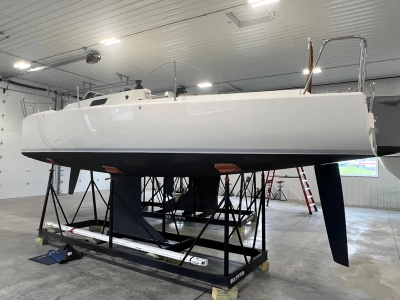 The Image of 2024 J Boats J/9 sailboat in indoor storage on a stand. - 0
