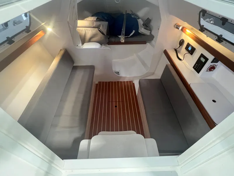 Slide: The Image of 2024 J Boats J/9 interior cabin with seating, table, and control panel. - 7