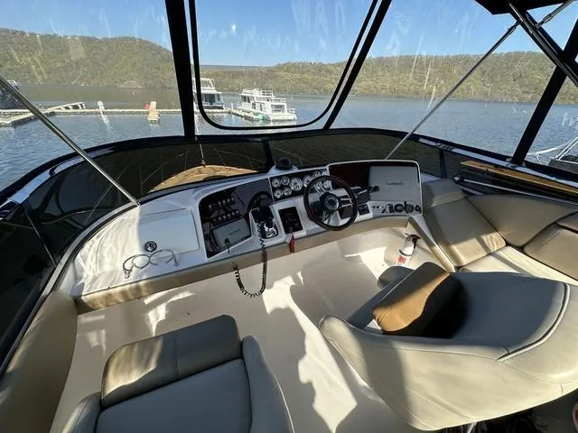 Slide: The Image of 2010 Regal 4080 Flybridge helm with panoramic lake view. - 10