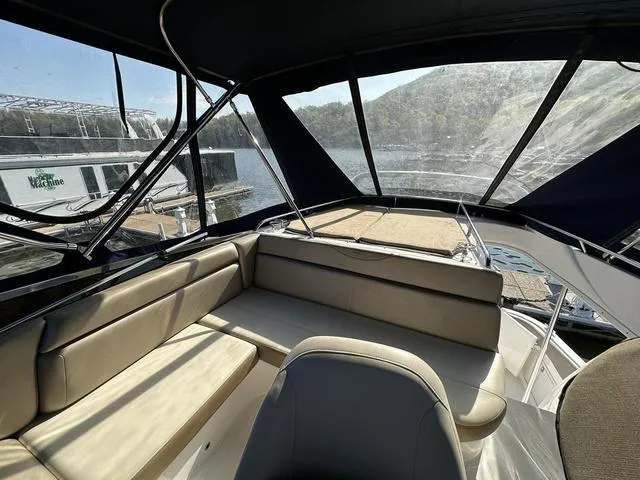 Slide: The Image of 2010 Regal 4080 Flybridge interior with beige seating and panoramic windows. - 11