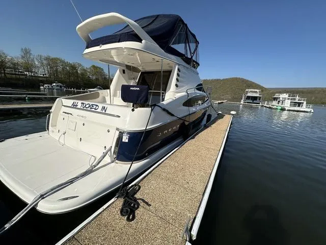 Slide: The Image of 2010 Regal 4080 Flybridge yacht docked at a marina on a sunny day. - 12
