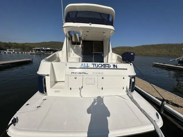 Slide: The Image of 2010 Regal 4080 Flybridge yacht docked at a marina. - 13