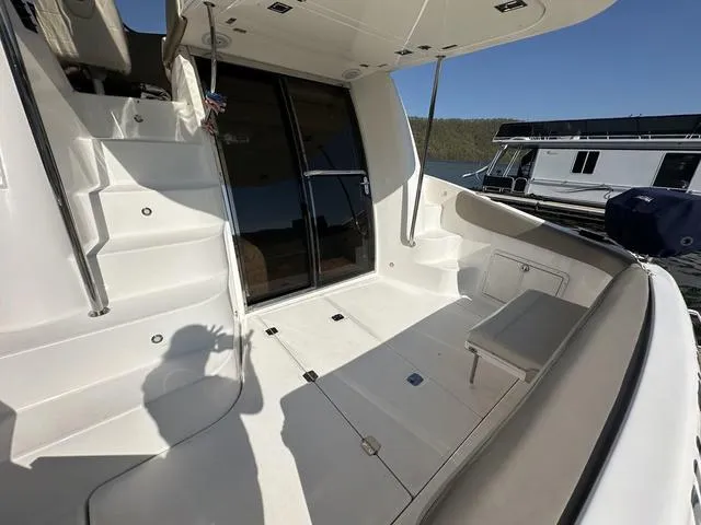 Slide: The Image of 2010 Regal 4080 Flybridge yacht with spacious deck and seating area. - 14