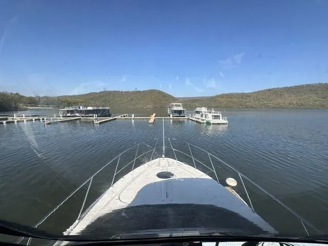 Slide: The Image of View from Regal 4080 Flybridge 2010 yacht approaching marina docks on a calm lake. - 16
