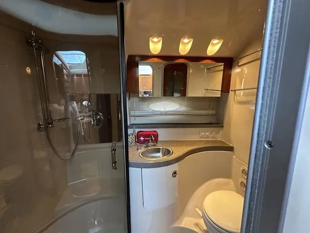 Slide: The Image of 2010 Regal 4080 Flybridge yacht bathroom with shower, sink, and toilet. - 4