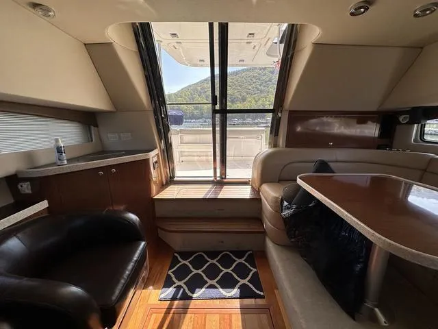 Slide: The Image of Interior of 2010 Regal 4080 Flybridge yacht with seating area and outdoor view. - 6