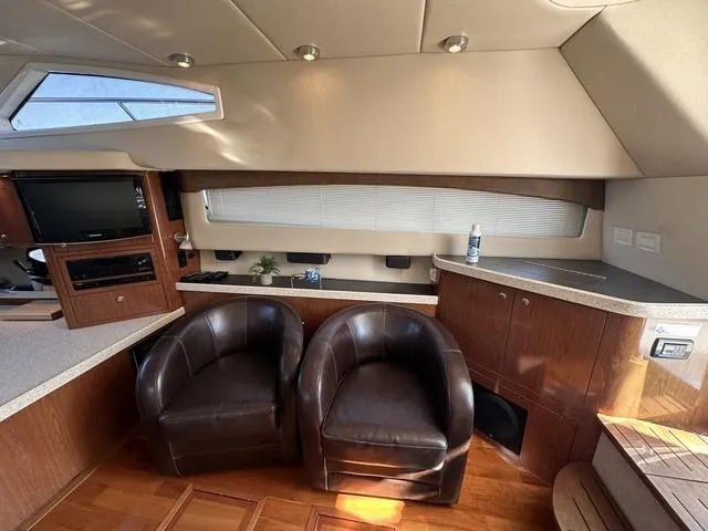 Slide: The Image of Luxurious interior of 2010 Regal 4080 Flybridge with leather chairs and modern amenities. - 8