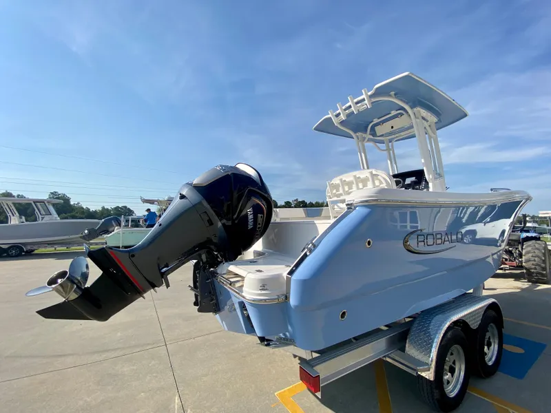 Slide: The Image of 2024 Robalo R232 Explorer boat on trailer with outboard motor. - 1