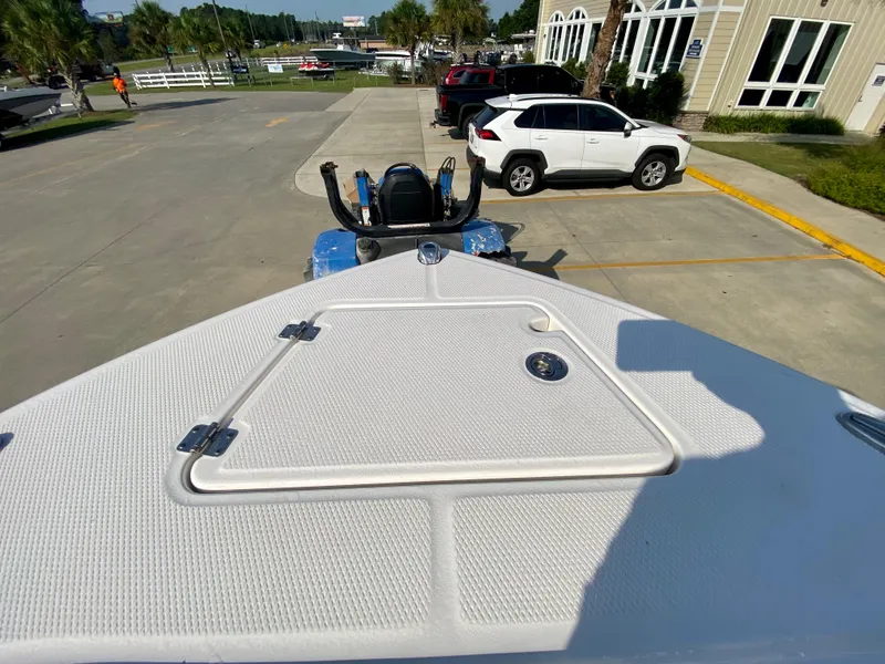 Slide: The Image of 2024 Robalo R232 Explorer boat bow view in a parking lot. - 25