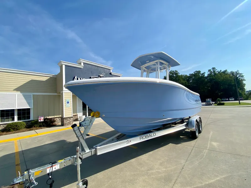 Slide: The Image of 2024 Robalo R232 Explorer boat on a trailer outside a dealership. - 4