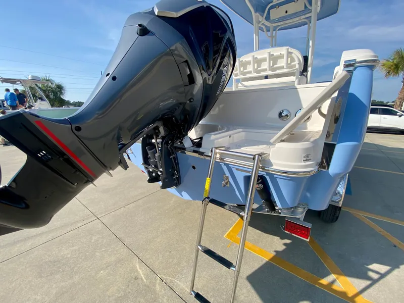 Slide: The Image of 2024 Robalo R232 Explorer boat with outboard motor and boarding ladder. - 5