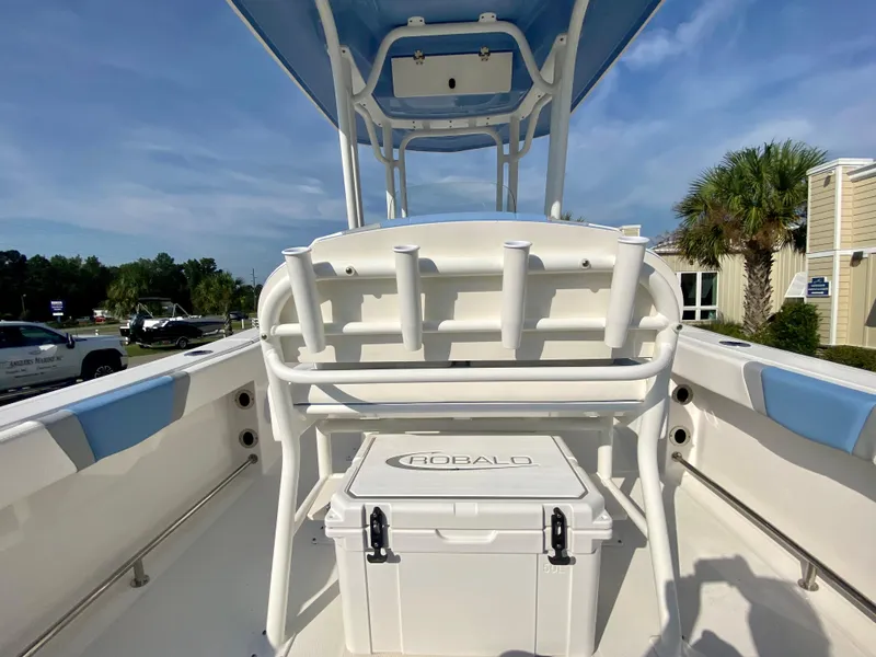Slide: The Image of 2024 Robalo R232 Explorer boat interior with rod holders and cooler. - 9