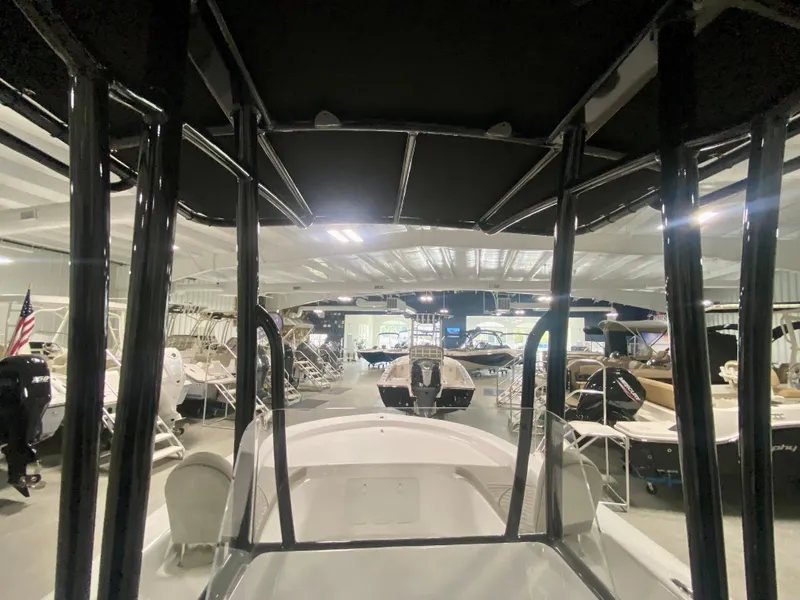 Slide: The Image of 2024 Savannah SS21 boat displayed in a showroom with other boats. - 14