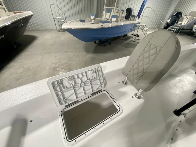 Slide: The Image of 2024 Savannah SS21 boat interior with open storage compartment and cushioned seat. - 23