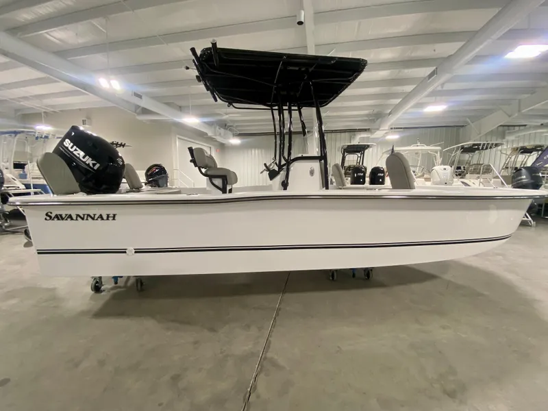 Slide: The Image of 2024 Savannah SS21 boat in showroom, side view with Suzuki outboard motor. - 3