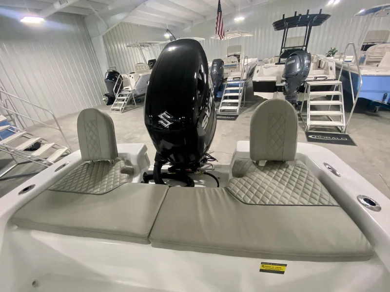 Slide: The Image of 2024 Savannah SS21 boat interior with Suzuki outboard motor in showroom. - 6