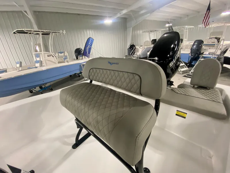 Slide: The Image of 2024 Savannah SS21 boat interior with cushioned seating in showroom. - 12