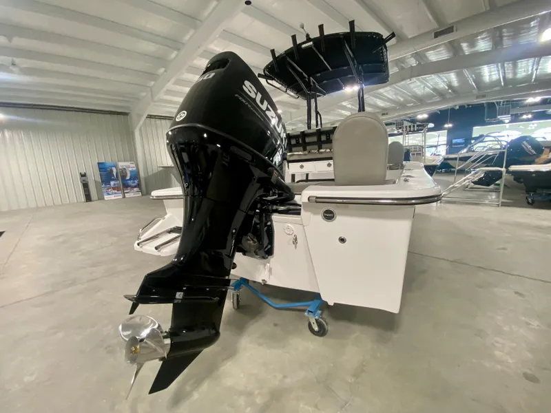 Slide: The Image of 2024 Savannah SS21 boat with Suzuki outboard motor in showroom. - 2