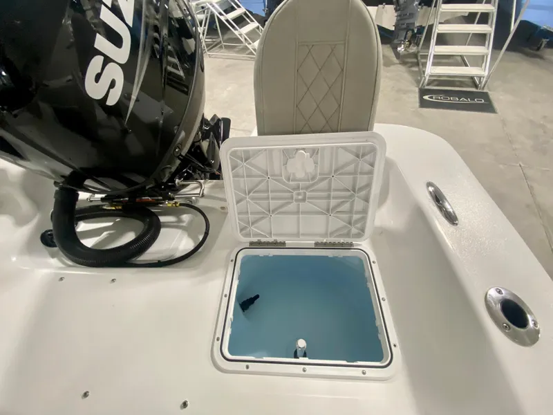 Slide: The Image of 2024 Savannah SS21 boat with open storage compartment and Suzuki outboard motor. - 8