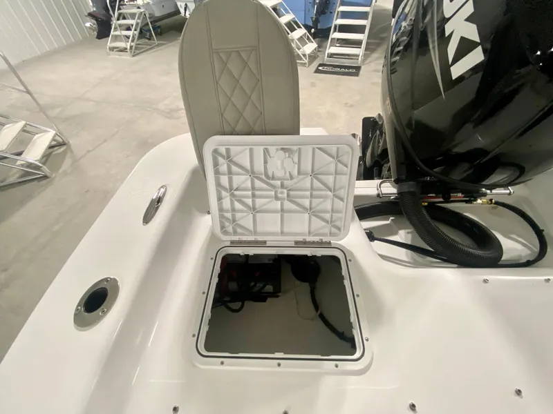 Slide: The Image of 2024 Savannah SS21 boat with open storage compartment and Suzuki outboard motor. - 9