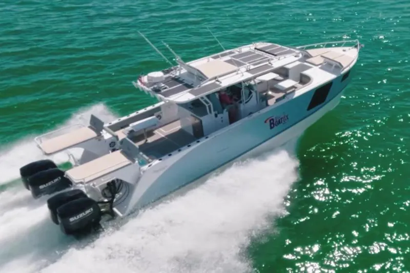 The Image of 2024 YachtCat 41 cruising on vibrant turquoise waters, showcasing sleek design and powerful engines. - 0