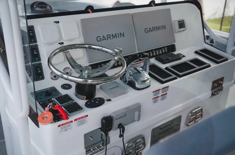 Slide: The Image of Control panel of 2024 YachtCat 41 featuring dual Garmin displays and modern navigation equipment. - 12