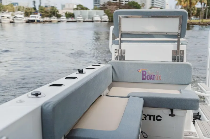 Slide: The Image of 2024 YachtCat 41 boat seating area with water view and docked yachts in the background. - 19