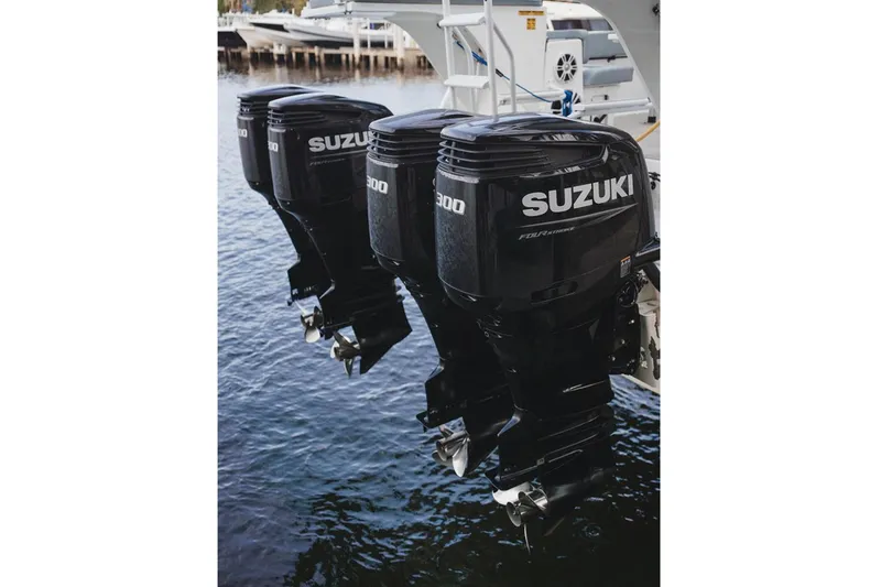 Slide: The Image of Triple Suzuki outboard motors on 2024 YachtCat 41, docked in marina. - 23