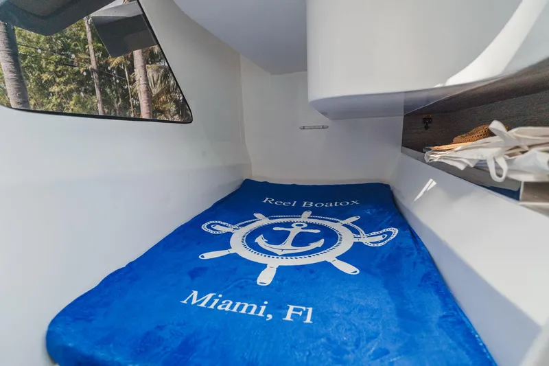 Slide: The Image of Cozy cabin interior of 2024 YachtCat 41 with blue nautical-themed bedding. - 26
