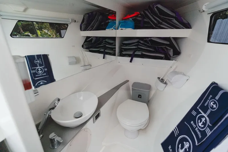 Slide: The Image of Modern YachtCat 41 bathroom with sink, toilet, and nautical-themed towels, 2024 model. - 27