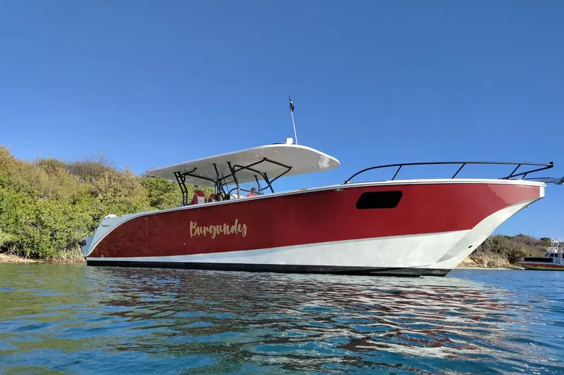 Slide: The Image of 2024 YachtCat 41 in water, red and white design, clear blue sky background. - 30