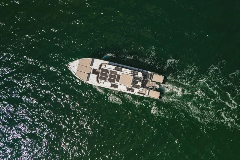 Slide: The Image of Aerial view of 2024 YachtCat 41 cruising on open water. - 5