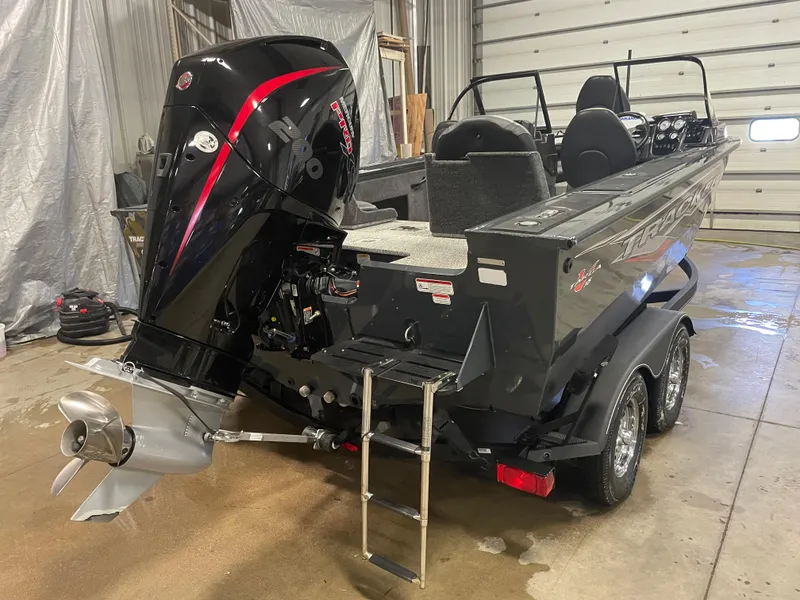 Slide: The Image of 2021 Tracker Targa V-18 WT fishing boat in a garage, rear view. - 2