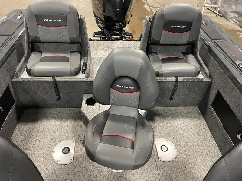 Slide: The Image of 2021 Tracker Targa V-18 WT boat interior with three gray and red seats. - 4