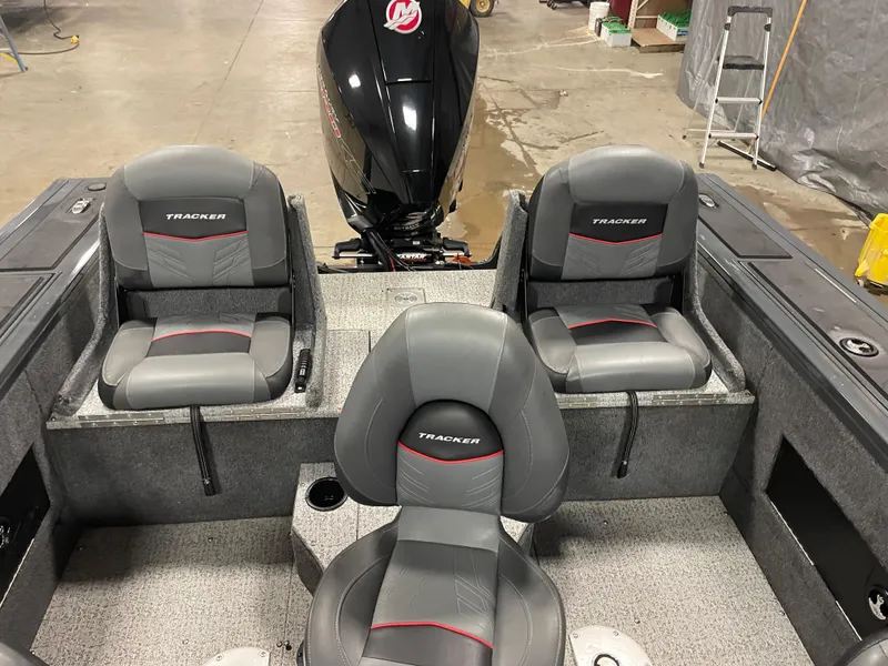 Slide: The Image of 2021 Tracker Targa V-18 WT boat interior with three gray seats and outboard motor. - 5
