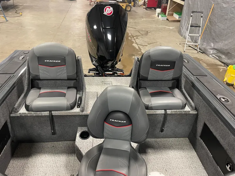 Slide: The Image of 2021 Tracker Targa V-18 WT boat interior with three gray seats and a Mercury outboard motor. - 6