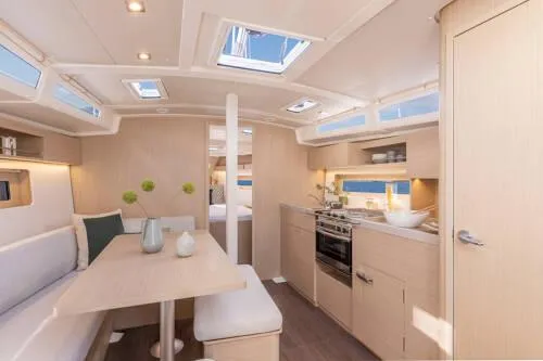 Slide: The Image of Interior of 2025 Beneteau Oceanis 37.1 yacht, featuring modern kitchen and dining area. - 10