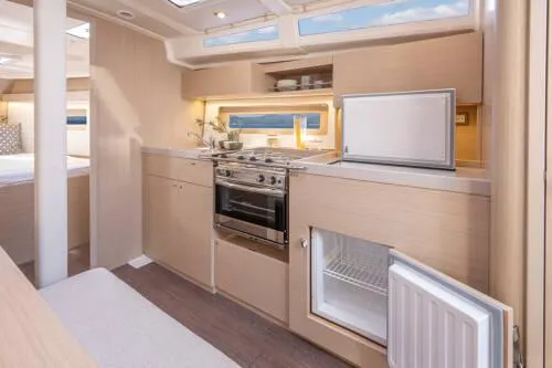 Slide: The Image of Modern kitchen interior of 2025 Beneteau Oceanis 37.1 yacht, featuring sleek cabinetry and appliances. - 11